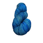 Blue skein of yarn on a wooden surface