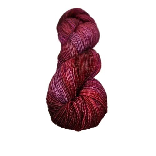 Red and purple skein of yarn on a wooden surface
