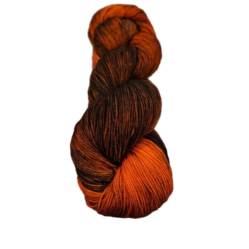 Skein of orange and brown yarn on a wooden surface