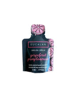Eucalan grapefruit pamplemousse laundry detergent pod on a wooden surface