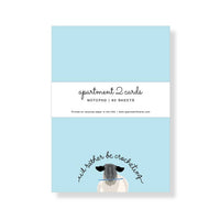 notepad with blue sheets, sheep with crochet hook and the saying "I'd rather be crocheting"