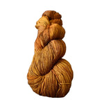 Skein of orange yarn on a wooden surface