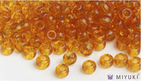 Miyuki 6/0 glass seed beads in the color 133 Transparent Amber