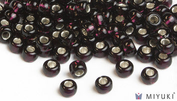 Miyuki 6/0 glass seed beads in the color 2428 Silverlined Dark Violet