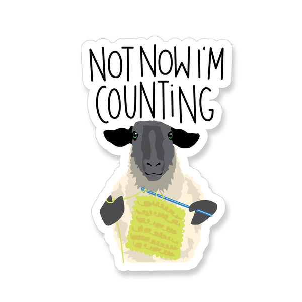 Vinyl Sticker with a crocheting sheep and the saying "Not Now I'm Counting"
