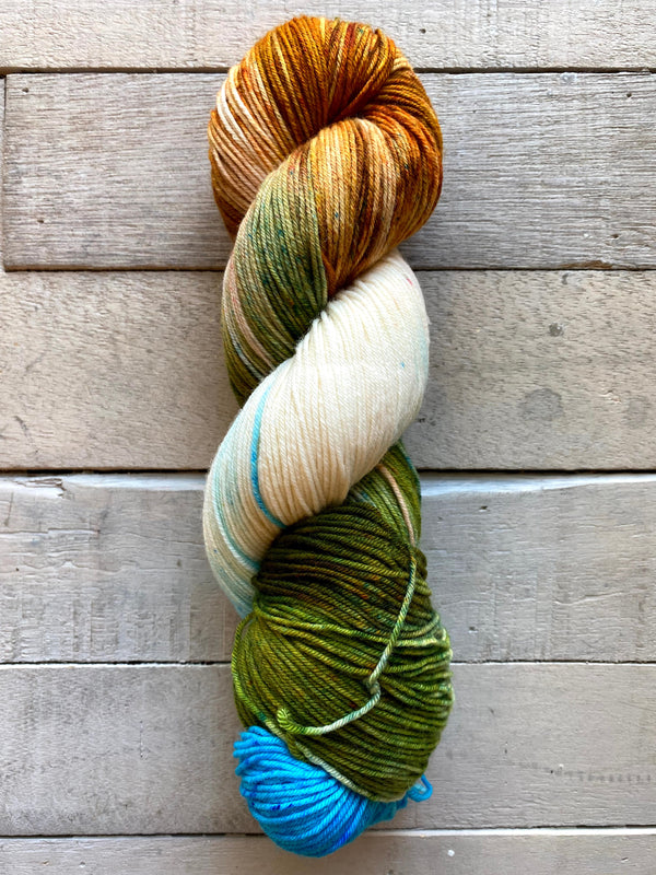 Knitted Wit hand dyed Sock yarn in the color Hovenweep National Monument (Gold, Green, Cream, Blue)