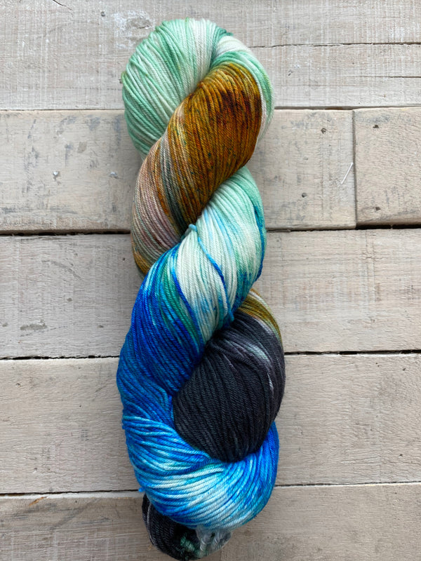 Knitted Wit hand dyed Sock yarn in the color Virgin Islands (blue, bright blue, cream, aqua, sandy brown)
