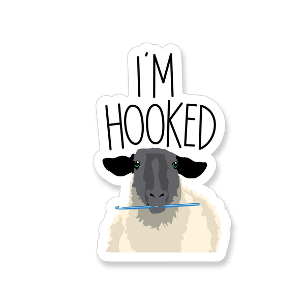 Vinyl Sticker with a sheep holding crochet hook and the saying "I'm Hooked"